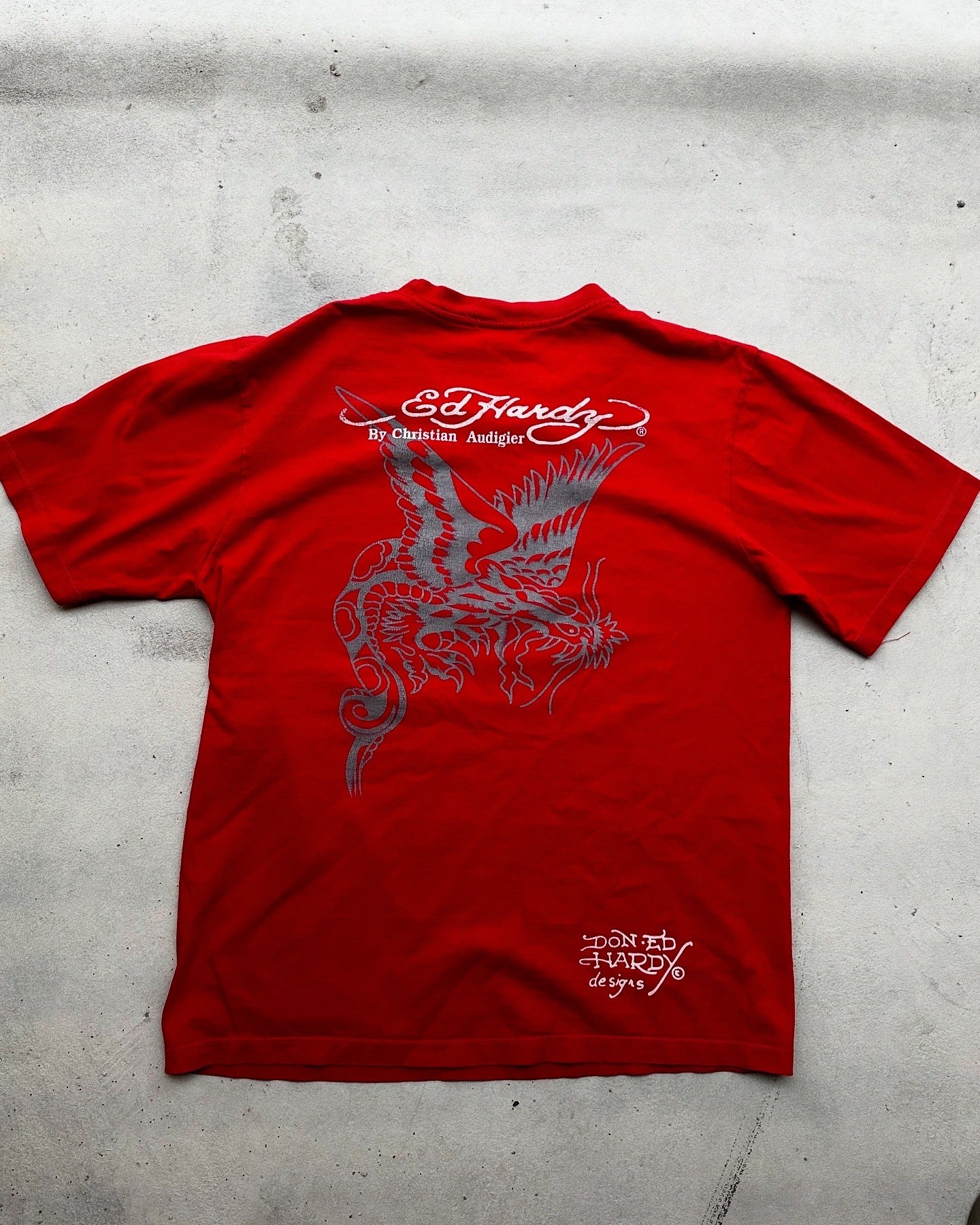 Y2K fashion statement piece—Ed Hardy red tee with vibrant design.