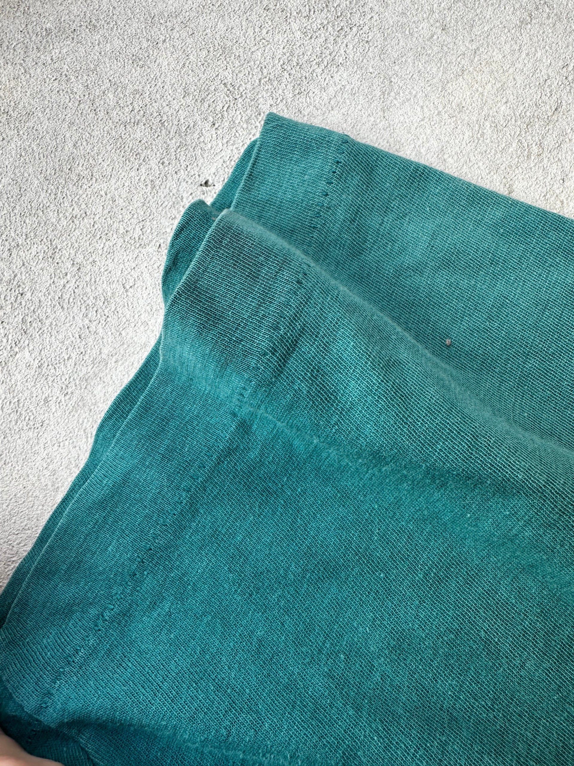 "Laid-flat vintage green T-shirt featuring classic boxy fit and single stitch construction