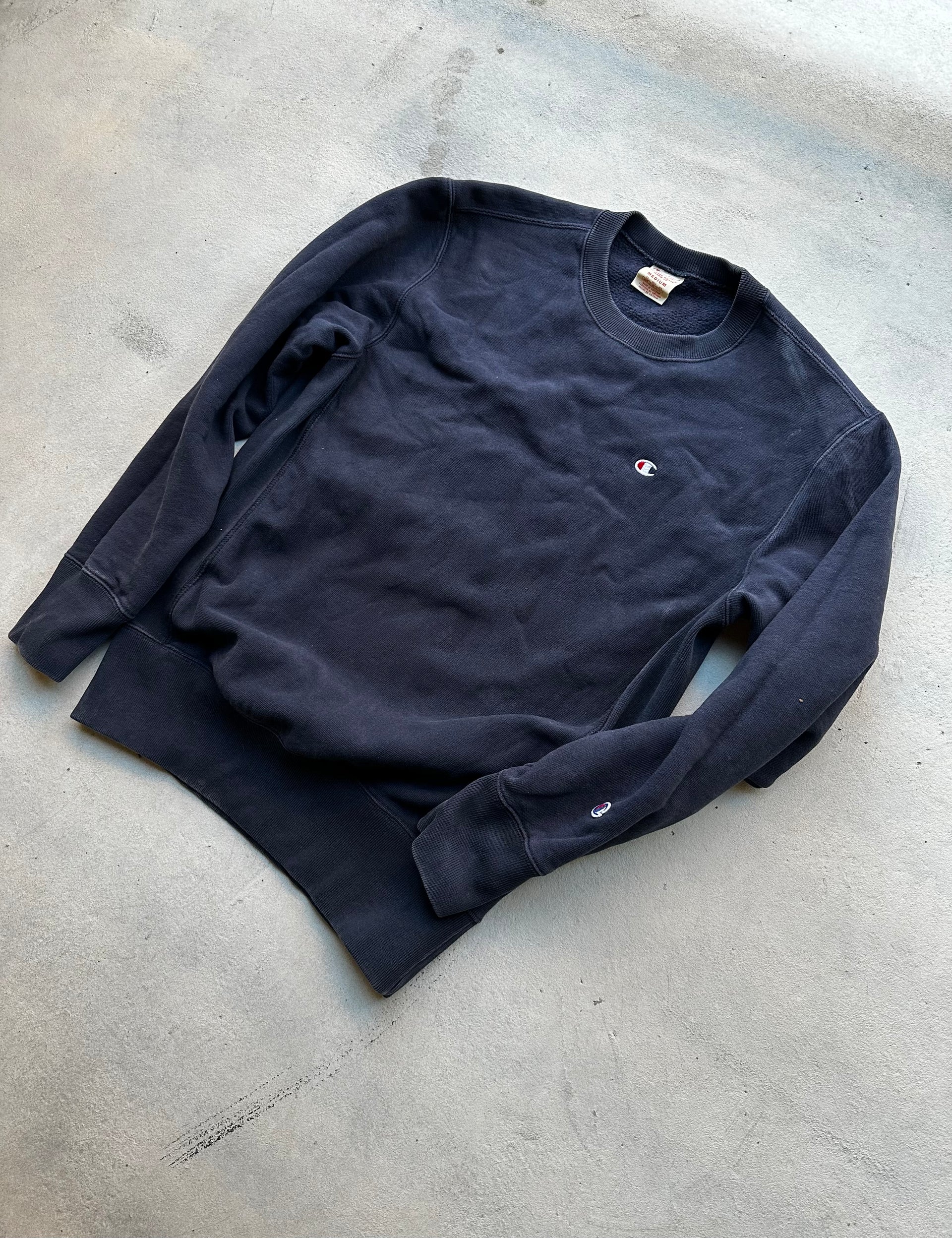 Champion navy sweatshirt with small chest and sleeve logos