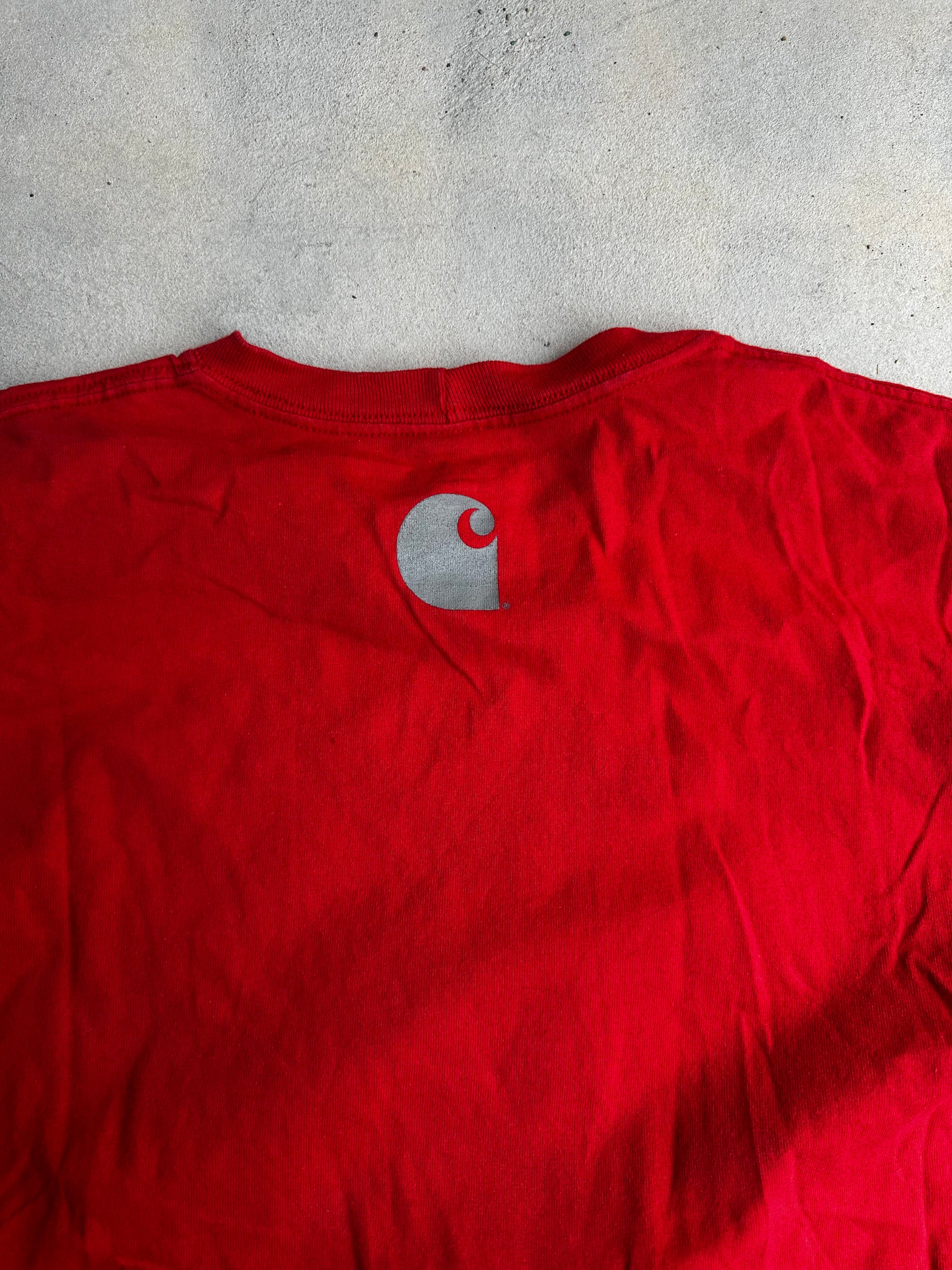 Rugged red Carhartt T-shirt with Western-inspired branding.