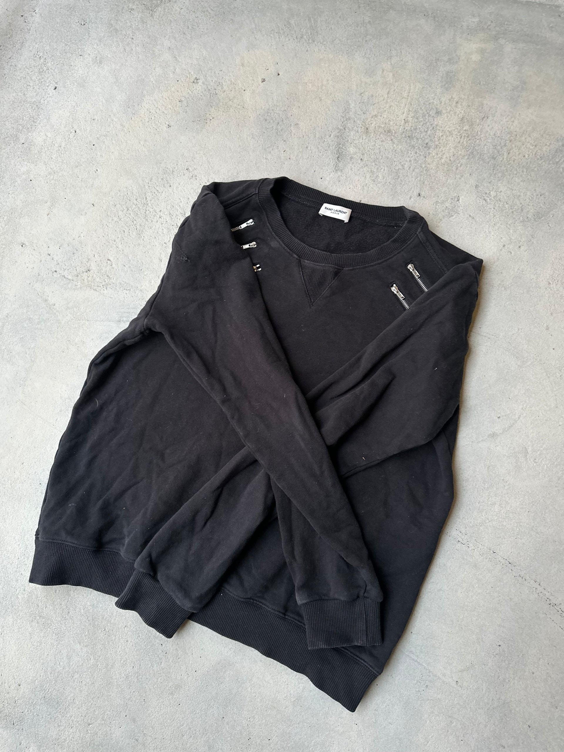 Saint Laurent black pullover featuring statement shoulder zippers.