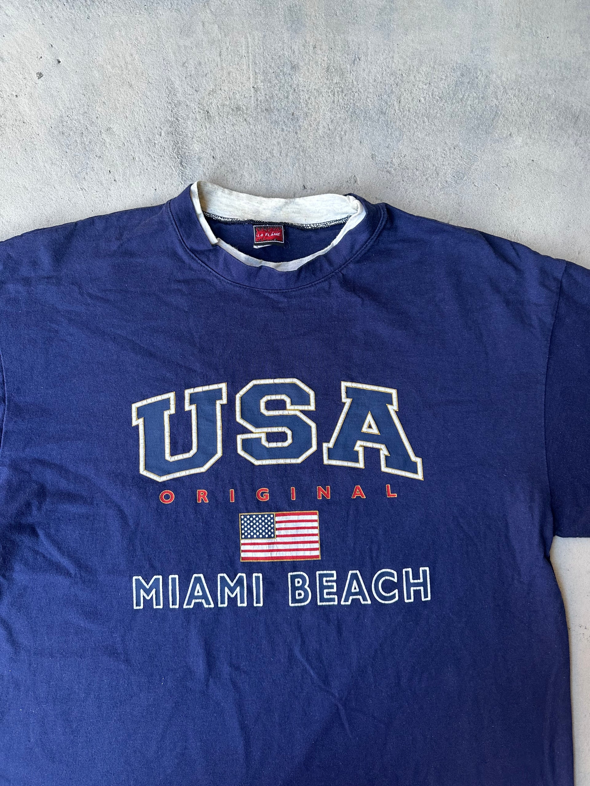 Vintage made-in-USA T-shirt with collegiate-style lettering and flag graphic