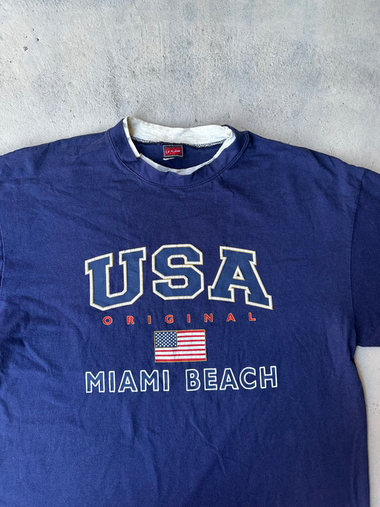 Vintage made-in-USA T-shirt with collegiate-style lettering and flag graphic