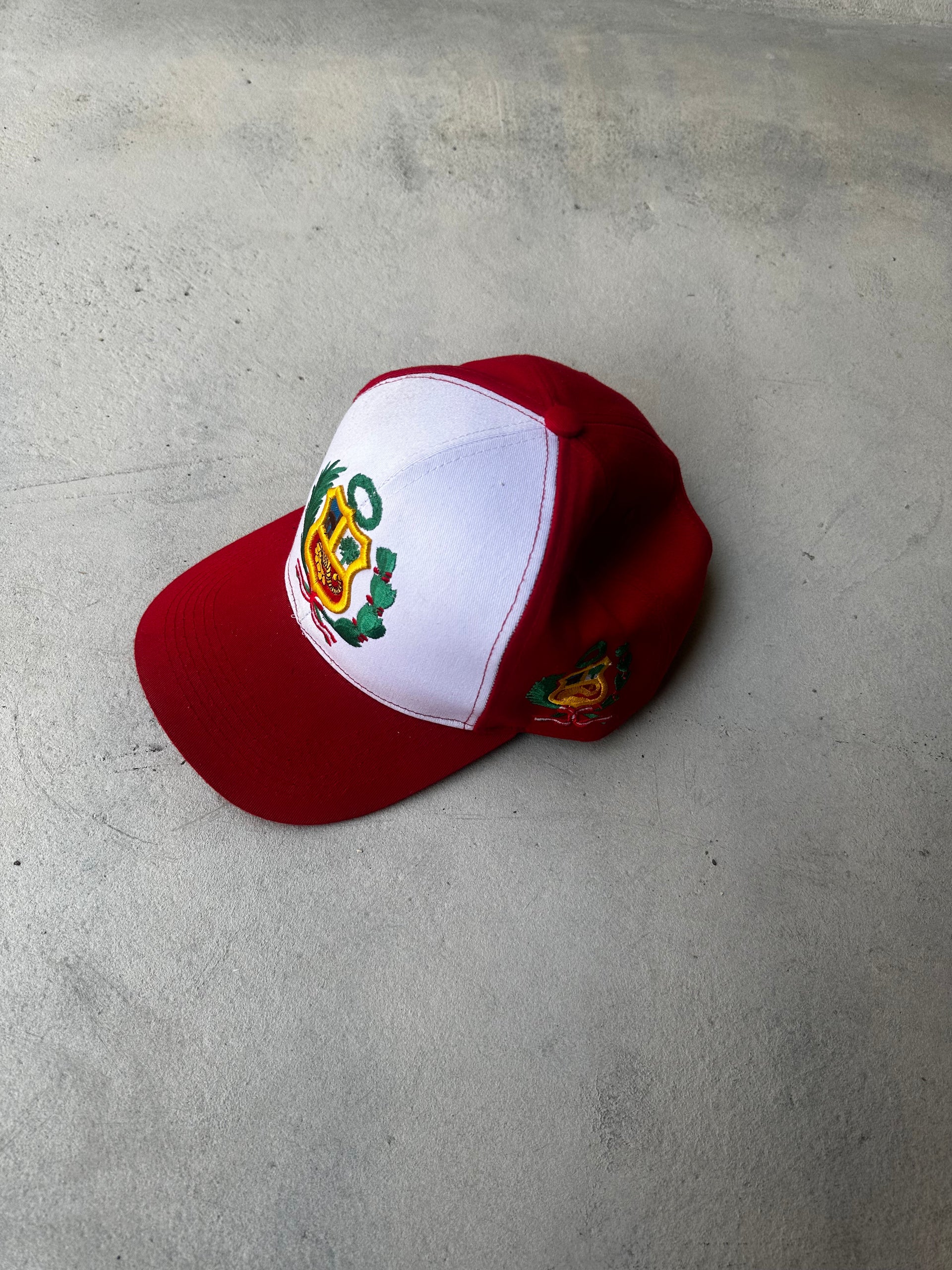 Laid-flat retro trucker cap with structured front panel and curved brim.