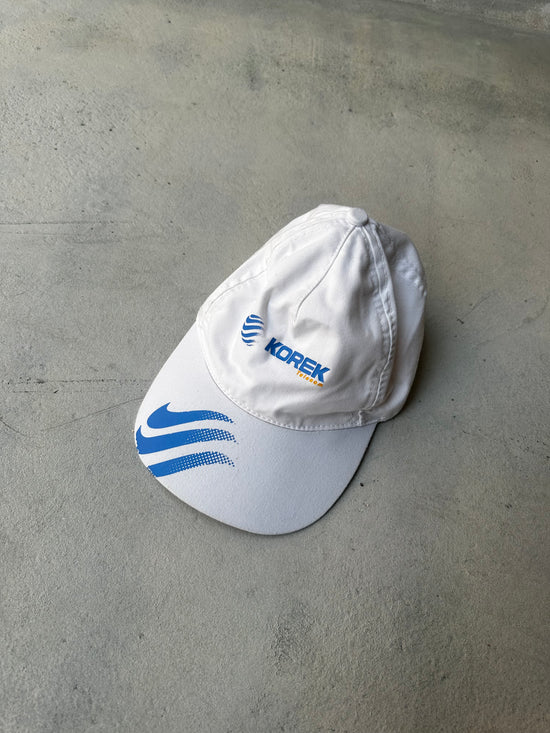 Laid-flat white Korek cap with soft fabric and structured fit.