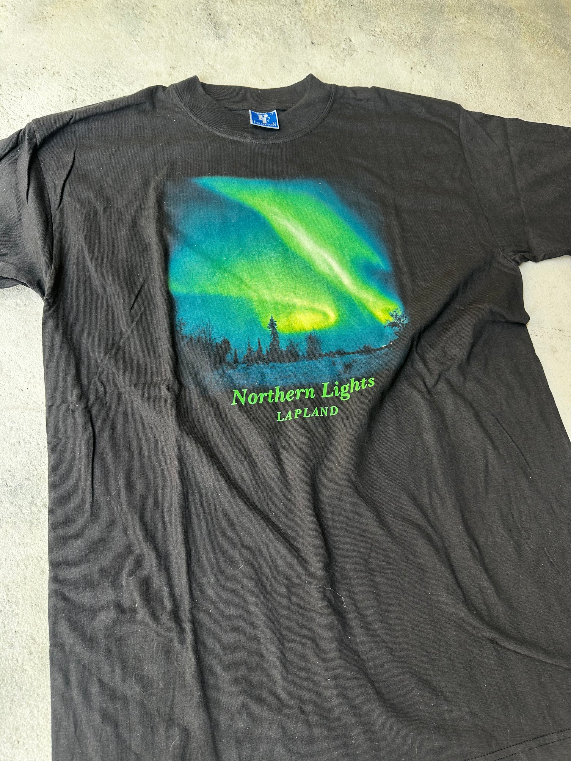 Laid-flat black aurora borealis T-shirt with soft worn-in fabric.