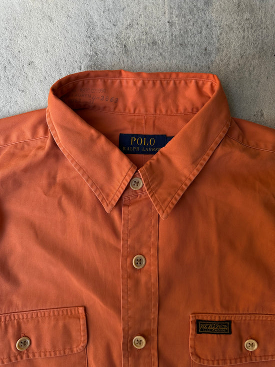 Close-up of textured cotton fabric on vintage Ralph Lauren faded orange shirt.