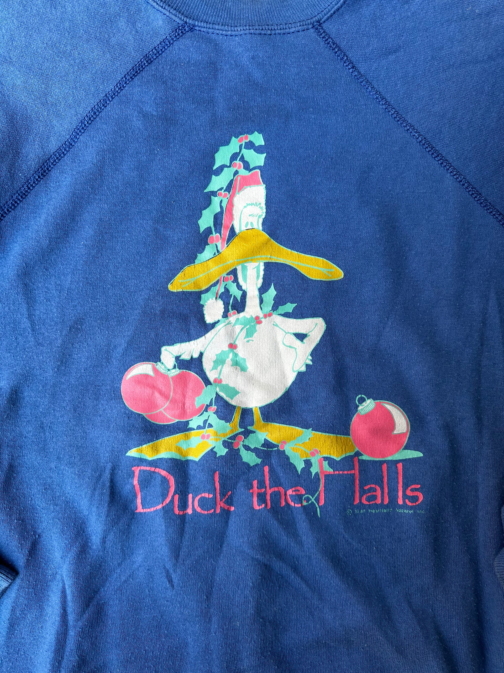 "Festive 90s crewneck sweatshirt featuring a holiday-themed duck graphic."