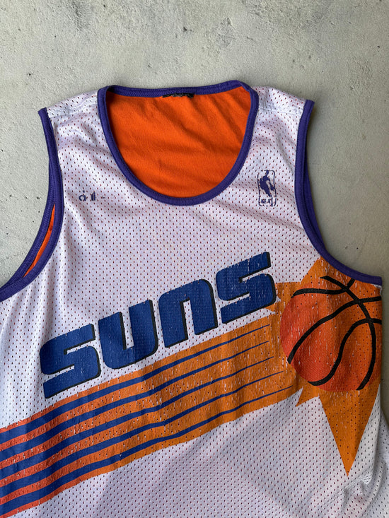 Close-up of Phoenix Suns graphic on vintage 90s basketball jersey.