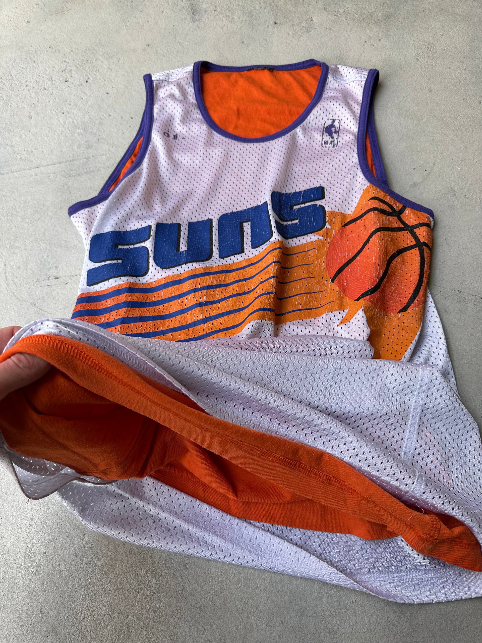Authentic 90s basketball-style jersey with Suns branding and breathable mesh fabric.
