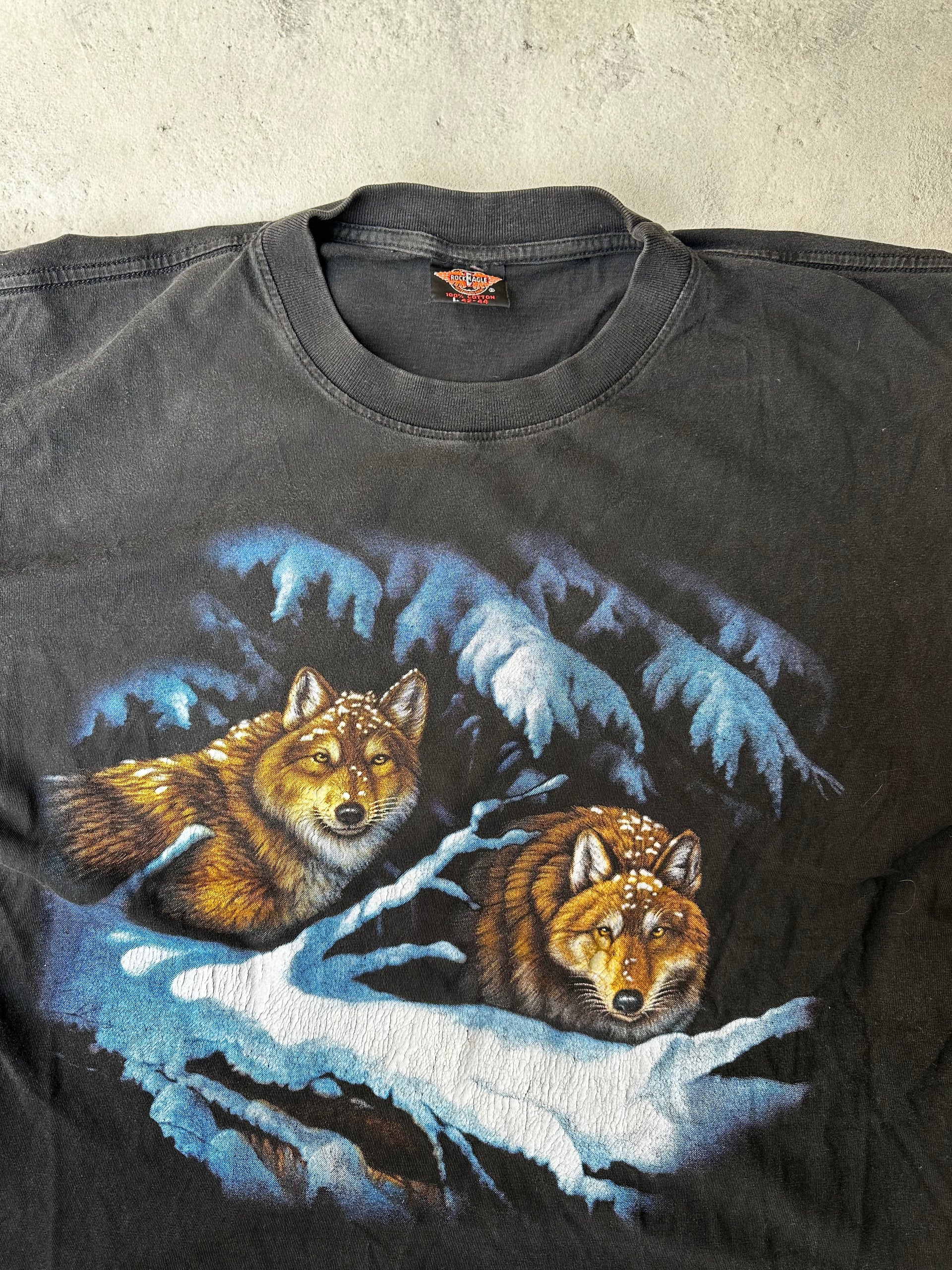 Close-up of faded wolf graphic on vintage single stitch black tee
