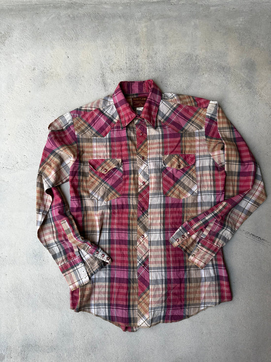 Classic plaid western shirt with pearl snap buttons and pointed yoke."