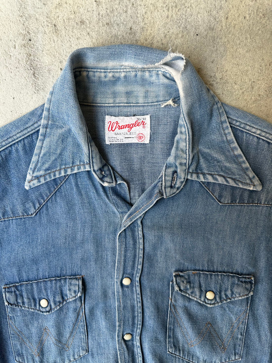 Laid-flat vintage Wrangler denim shirt, showing worn-in details and rugged character.