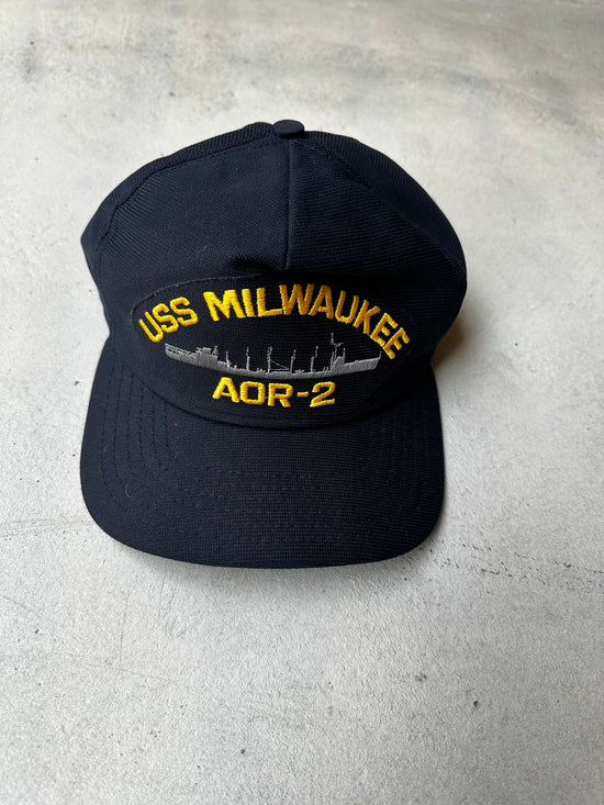 Close-up of USS Milwaukee AOR-2 cap, featuring military-style embroidery.