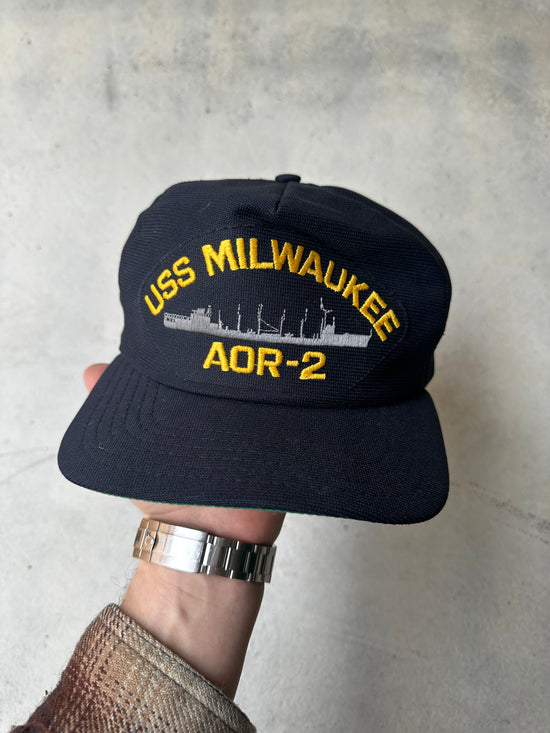 Vintage USS Milwaukee AOR-2 navy cap in black with yellow embroidered lettering and ship design.