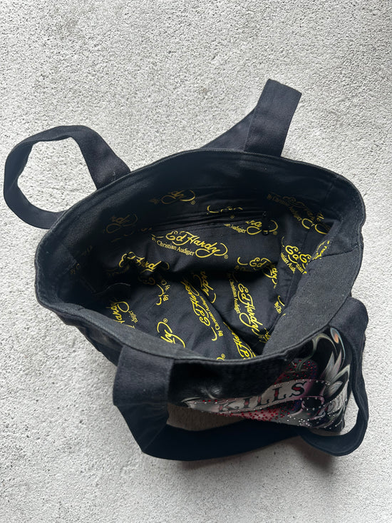"Ed Hardy tote bag, reversible design with a bold tattoo-inspired graphic on one side and plain black on the other."