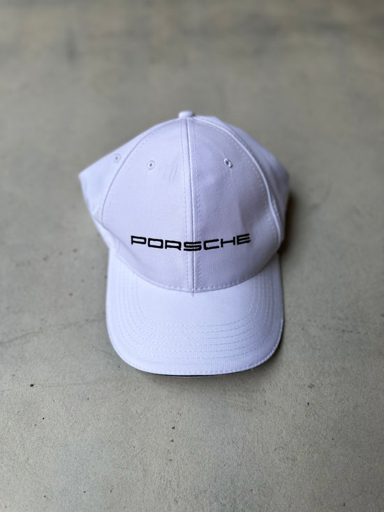 Classic Porsche hat with black stitching, featuring a sleek and sporty design.
