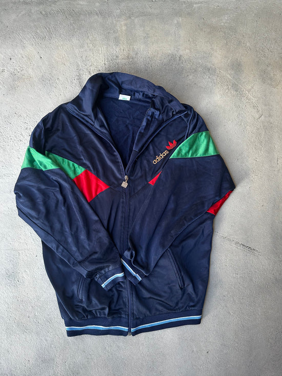 Retro Adidas Track Jacket from the 80s – Zip-up style with striking geometric color blocking.
