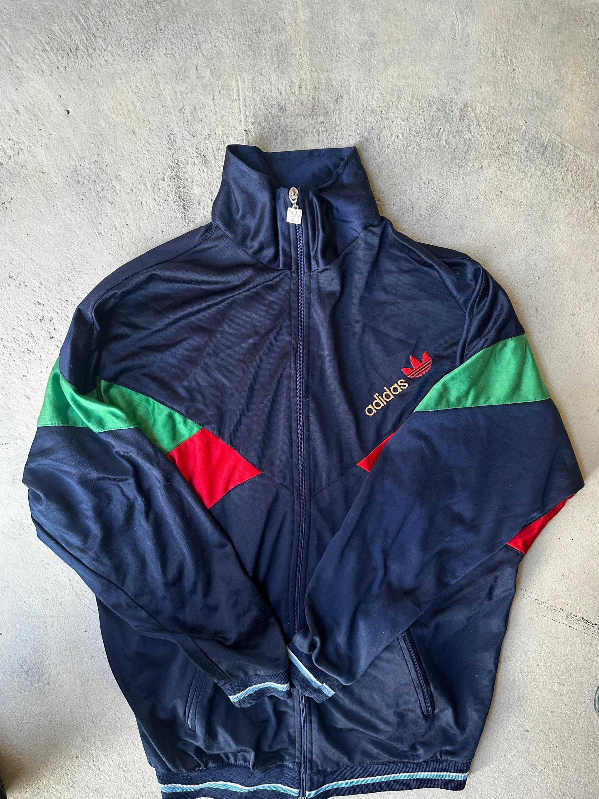 Rare 80s Adidas Track Top – Trefoil embroidery, contrasting panels, and a sleek athletic fit.
