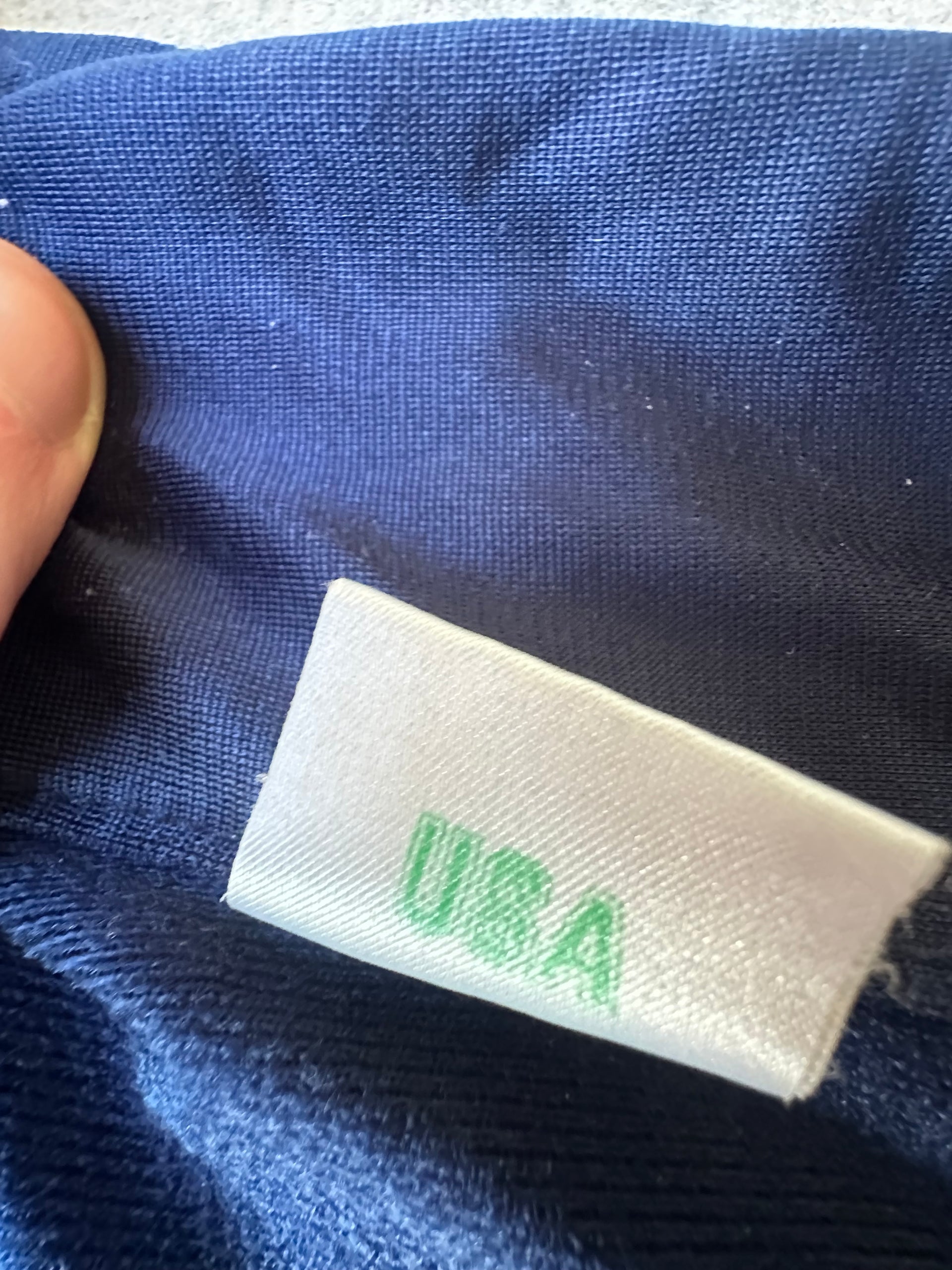 Vintage Adidas Jacket – 1980s sportswear staple, navy with red & green accents, timeless style.
