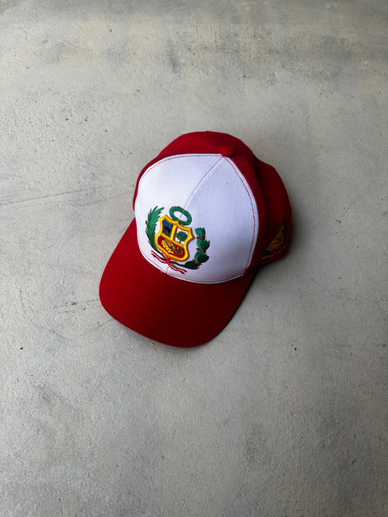 Vintage red and white trucker cap with embroidered Peruvian coat of arms