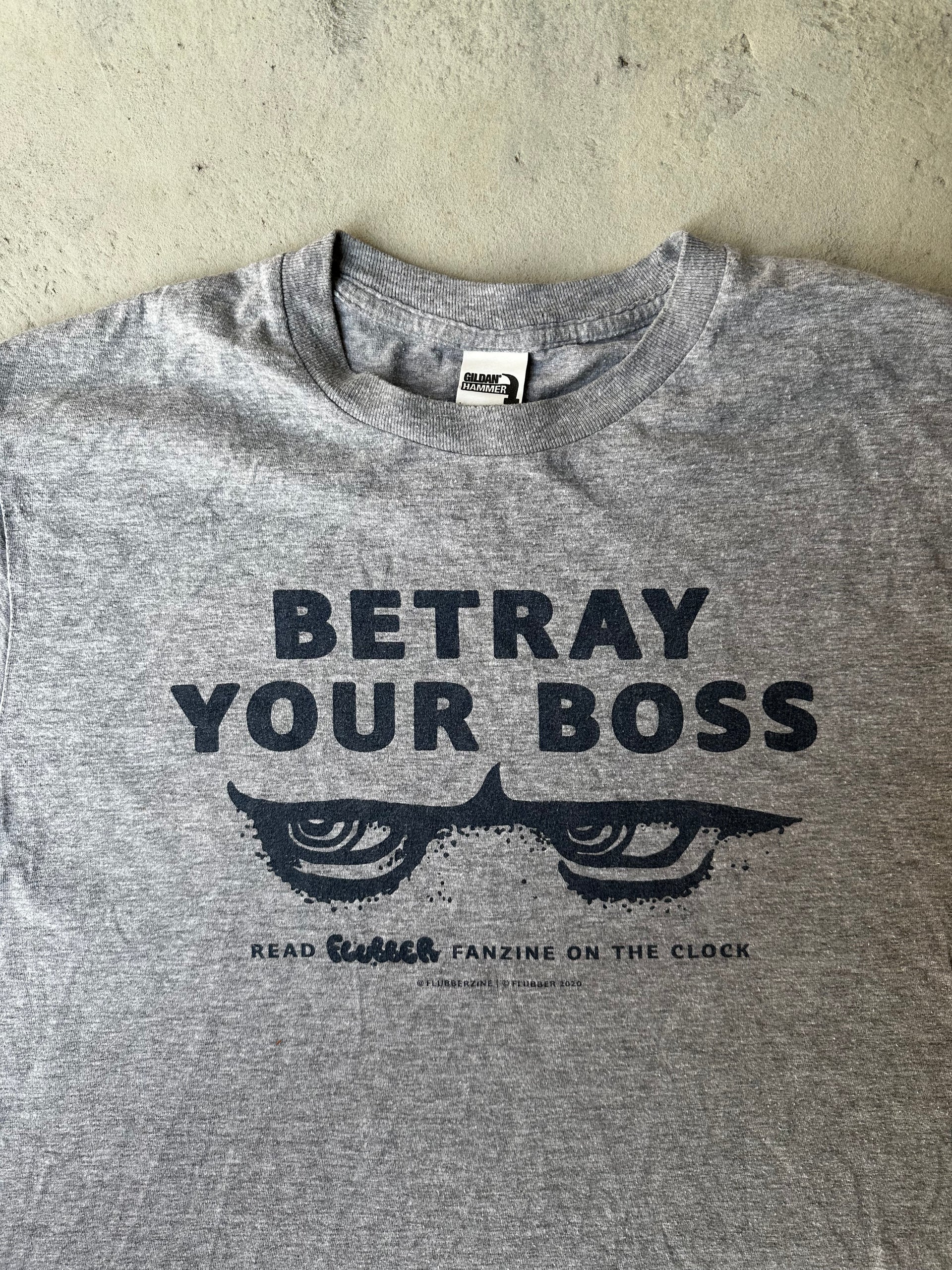 Close-up of worn-in text print on vintage Betray Your Boss T-shirt.