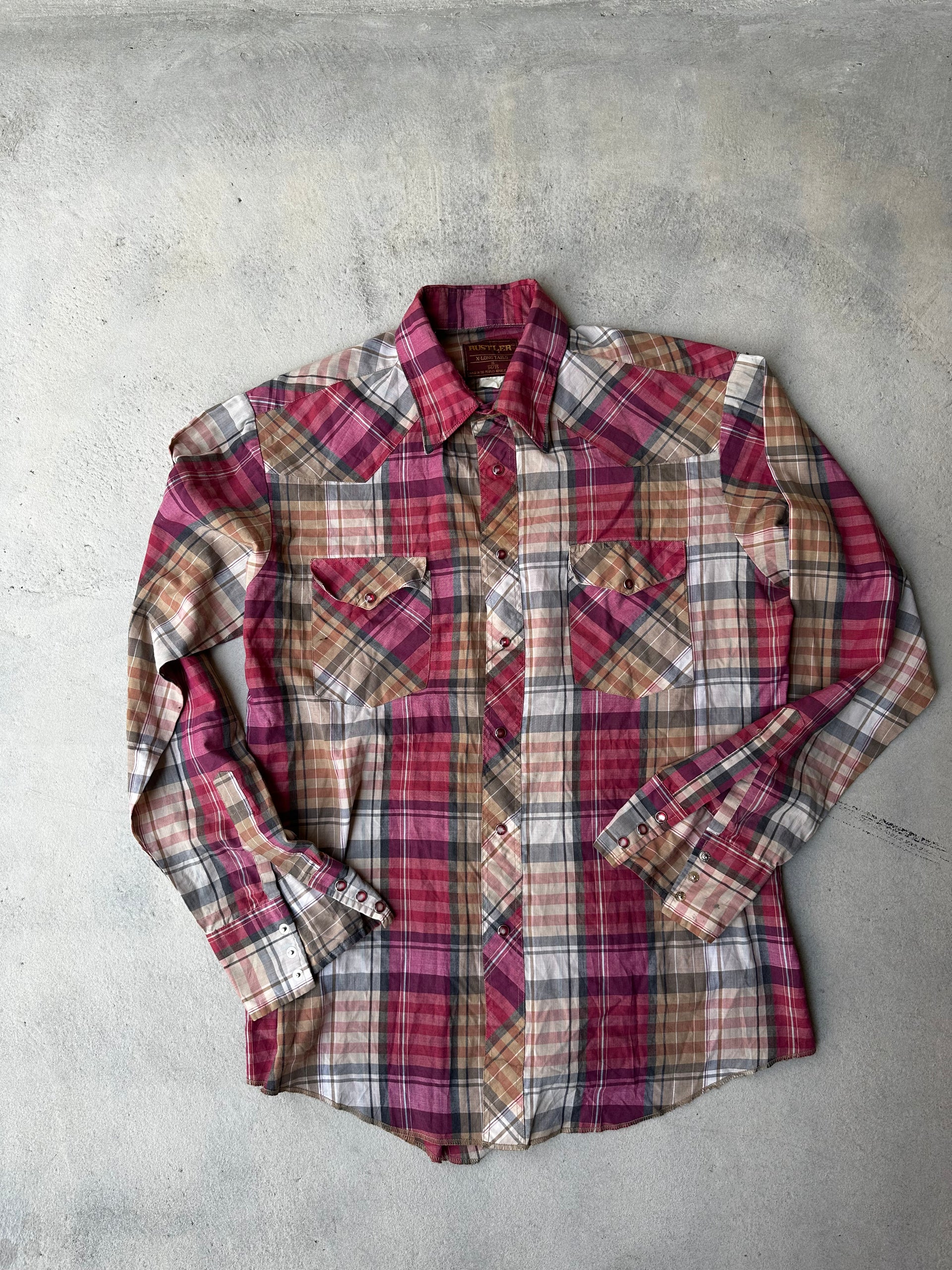 Classic plaid western shirt with pearl snap buttons and pointed yoke."

