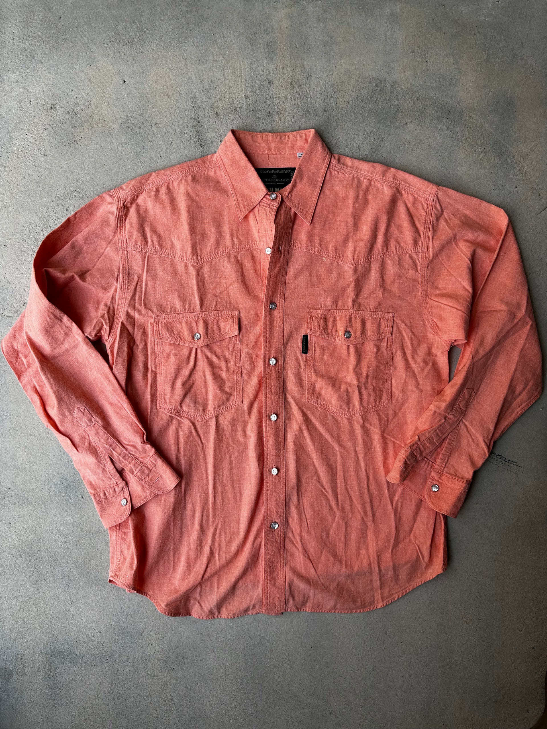 Vintage red Mish Mash western shirt laid flat, showing distressed texture and classic design